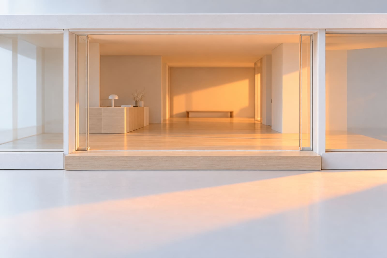 The entrance of the house's card model: a tall glass door slid fully open, warm light from inside falling across a timber step on to the table.