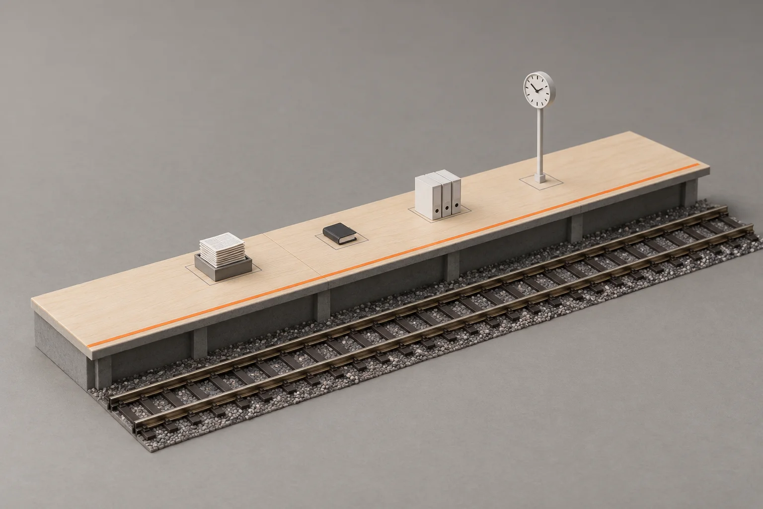 A scale model of one railway platform with an orange line along its edge: a tray of letters, a diary and three box files each set on its mark, beside a station clock.